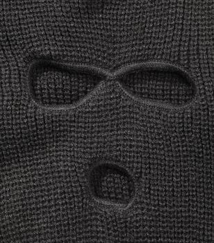 Detail of a Black ski mask aka Balaclava isolated on white with natural shadows.