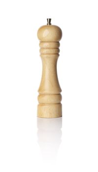 Wooden pepper mill on white reflectice background