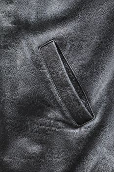 Pocket of an old worn black weather jacket