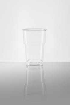 Empty disposable plastic cup made of clear plastic