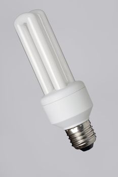 Energy saving fcompact fluorescent bulb on grey