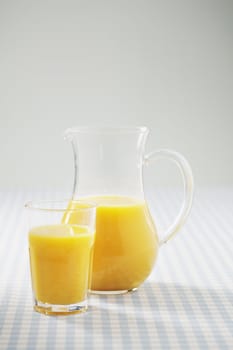 Orange juice in a glass and in a jug