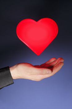 A glowing heart shape hovering above a hand