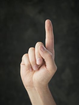 Hand pointing up with an index finger