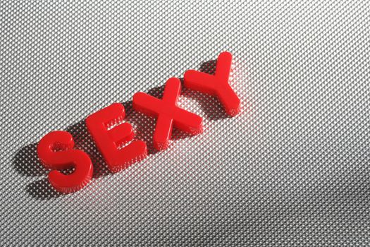 The word "Sexy" spelled with red plastic letters