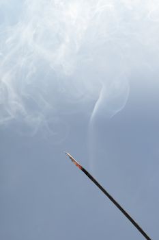 A Smoking incense on blue background