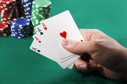 Man holding four aces in his hand.