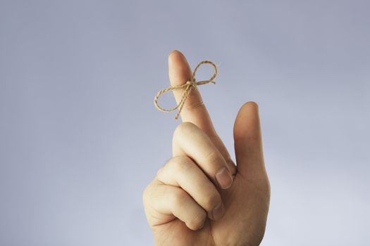 A string tied around an index finger