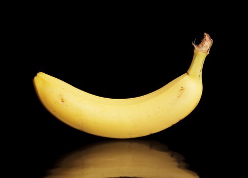 A Banana on black reflective surface. The reflection is real, no photoshop there.