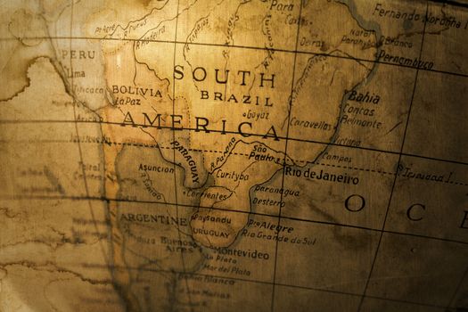 An old toy globe map of South America grunged up in a photomontage