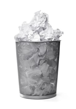 Wastepaper basket filled with crumpled papers