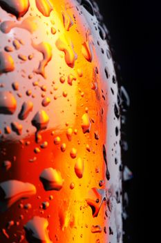 Brown beer bottle with some droplets. Short depth-of-field