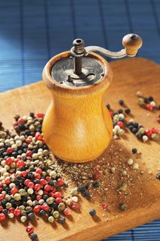 Old Pepper grinder mill with different dried peppers