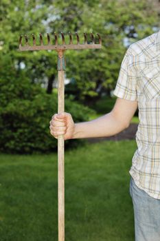 Man holding a rake in his hand