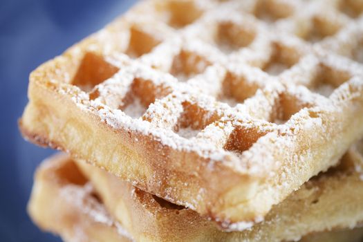 Closeup of waffles with sprinkled sugar. Very short depth-of-field.