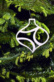 Bauble shape Christmas ornament in fresh green Christmas tree