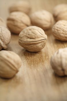 Whole walnuts on a wooden table