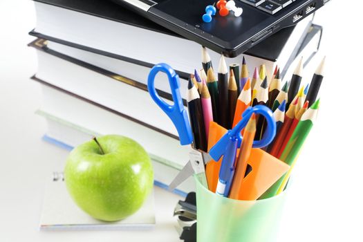 office supply and apple on white background