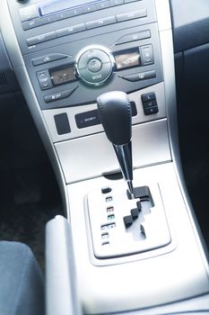 Interior of the modern car with buttons and the lever