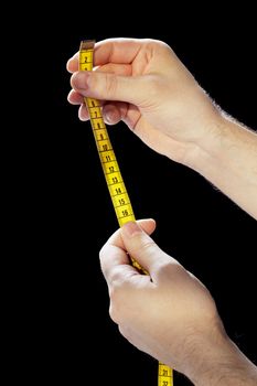 Hands holding a yellow tape measure