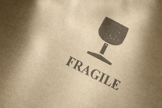 "Fragile" symbol printed on brown cardboard