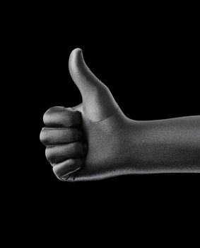 A Strange black gloved hand doing thumb up gesture