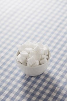 White sugar cubes in a small bowl