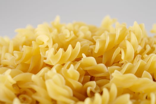 Uncooked pasta Fusilli, short depth-of-field.