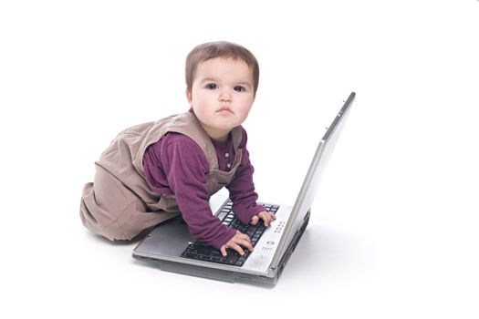 Baby girl with a laptop on white background
