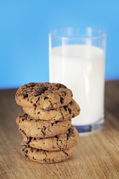 A Stack of chocolate chip cookies and a glass of milk