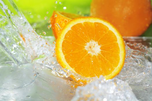 Orange fruit with splashing water