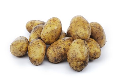 Dirty potatoes isolated on white with natural shadows