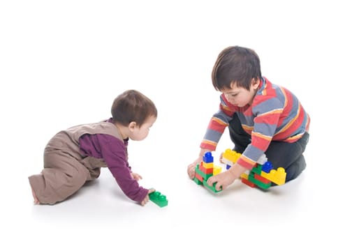 Brother and sister playing together over white background