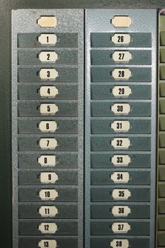 Numbered metallic card slots in an old factory