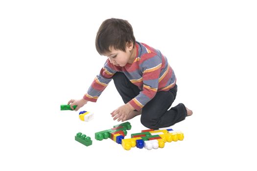 A toddler playing with a multicolored bricks