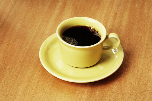 Yellow coffee cup on a table