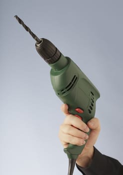 A Hand holding an electric drill tool