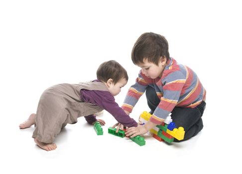 Brother and sister playing together over white background