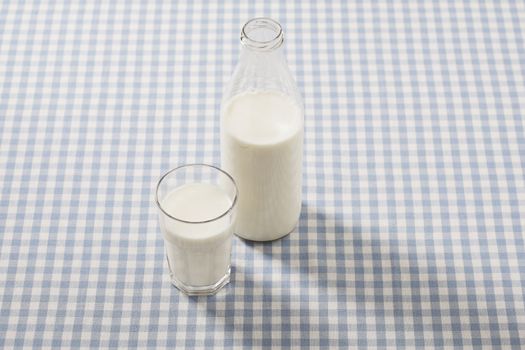 A Glass and bottle with milk