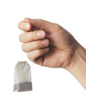 Hand holding a dry tea bag