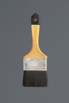 Yellow clean new paint brush on grey