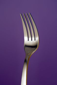 a fork against lila background