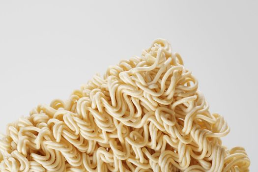 uncooked instant ramen noodles on grey background