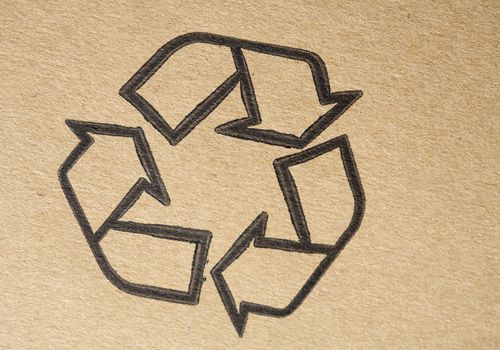 "Recyclable" universal symbol, printed on brown cardboard