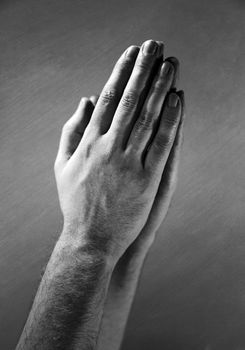 Hands clasped in a prayer.