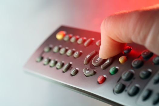 Digital television remote control in red light
