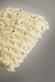 A Block of dried instant ramen noodles in closeup