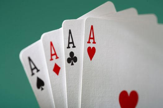 Playing cards with four aces.