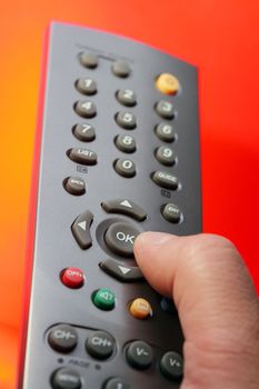 Thumb pressing "ok" button on a tv remote control