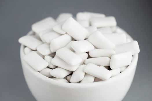 White rectangular chewing gum in a small white bowl